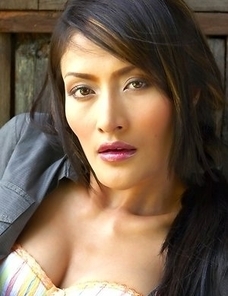 Bella Yong is a sexy babe that has on a dark shirt and shorts. She begins taking it off as she gives a sexy look to the camera.