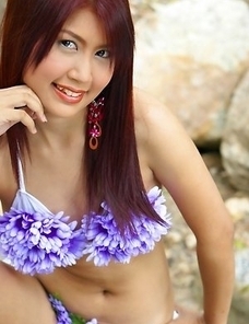 Check out this amazing shoot where stunning April Lim is wearing a cute purple flower bikini suit.