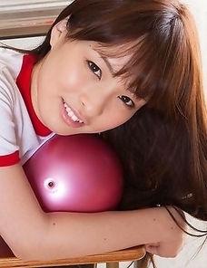 Maho Kiruma in sports equipment plays with ball on desk