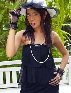 Mikiko Toyo looks like a Hollywood diva. She is wearing a white had and white pearls on black outfit. She looks so glamorous and sexy at the same time