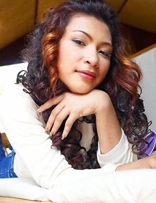 Piczy Pure lies on a couch and she stares at the camera. She takes down her top and her breasts are remarkable.