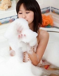 Aliana gets in a tub and rubs soap suds all over her young body. Then, she takes the shower head and wets herself so that her top sticks to her body.