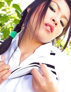 Aime Copony begins posing and she smiles for the camera while wearing a white and black top.