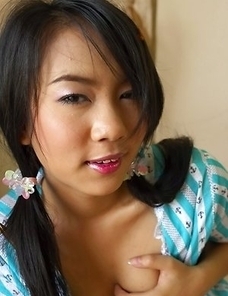 Dolla Dolaya lies on her stomach and gives that nice innocent smile.