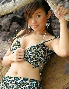 Katie Chung sits on a rock and she gets in a position that will get your mind in very freaky positions.