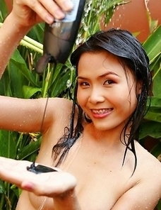 Loretta Ivy decides to show her sexiness by the pool. She has on a purple bikin and she is sitting by the pool smiling at the camera.