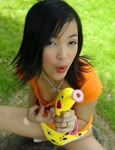 Mizuno Manabe has on an orange top with yellow panties. She struts around the room playing with a bubble blower.